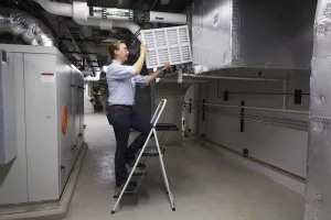 HVAC Service Member Installing Filter